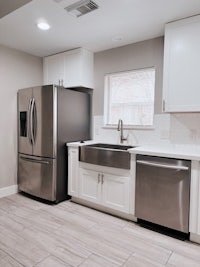 a kitchen with stainless steel appliances and white cabinets